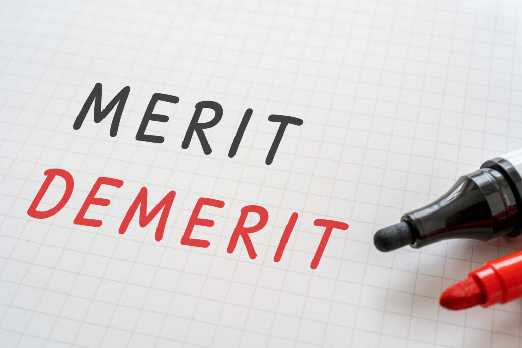 Merit demeritと書かれたノートとペン