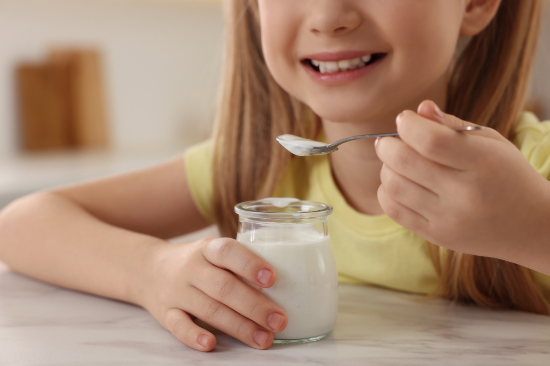 ヨーグルトを食べている子供