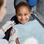 歯科医院で診察を受けて笑う少女